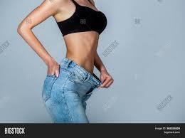 Lose weight and feel great lady with pants that are too big at the waist